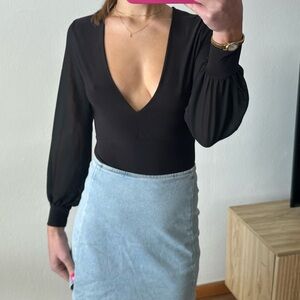Black, plunge necklined body suit.